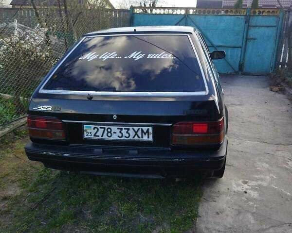 Черный Мазда 323, объемом двигателя 1.5 л и пробегом 249 тыс. км за 750 $, фото 1 на Automoto.ua