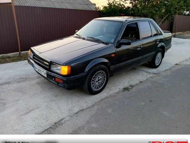 Черный Мазда 323, объемом двигателя 1.6 л и пробегом 300 тыс. км за 750 $, фото 1 на Automoto.ua