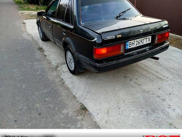 Черный Мазда 323, объемом двигателя 1.6 л и пробегом 300 тыс. км за 750 $, фото 3 на Automoto.ua