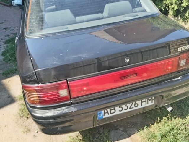 Черный Мазда 323, объемом двигателя 1.7 л и пробегом 187 тыс. км за 1500 $, фото 1 на Automoto.ua