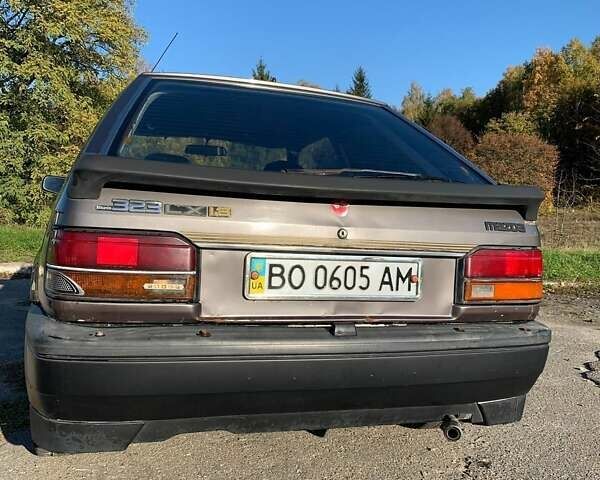 Коричневый Мазда 323, объемом двигателя 1.3 л и пробегом 475 тыс. км за 1300 $, фото 3 на Automoto.ua