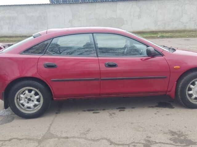 Красный Мазда 323, объемом двигателя 1.5 л и пробегом 367 тыс. км за 2400 $, фото 5 на Automoto.ua