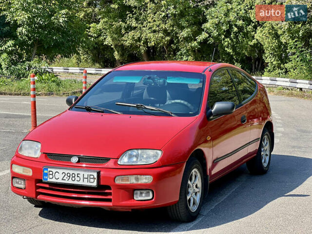 Красный Мазда 323, объемом двигателя 1.5 л и пробегом 300 тыс. км за 1999 $, фото 1 на Automoto.ua