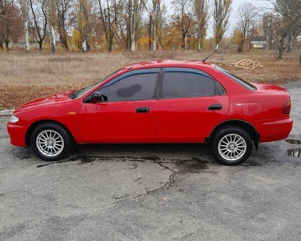 Червоний Мазда 323, об'ємом двигуна 1.49 л та пробігом 290 тис. км за 2800 $, фото 2 на Automoto.ua