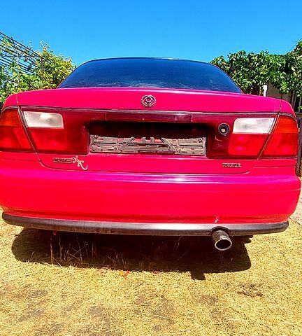 Красный Мазда 323, объемом двигателя 1.8 л и пробегом 300 тыс. км за 2300 $, фото 1 на Automoto.ua