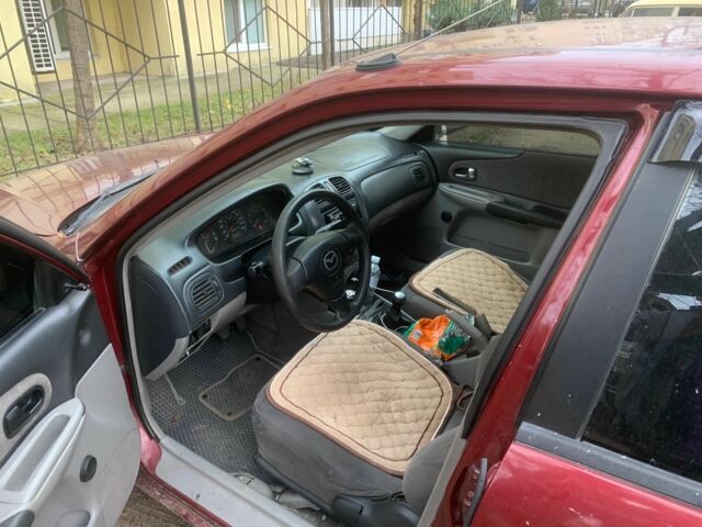 Червоний Мазда 323, об'ємом двигуна 2 л та пробігом 167 тис. км за 2400 $, фото 2 на Automoto.ua