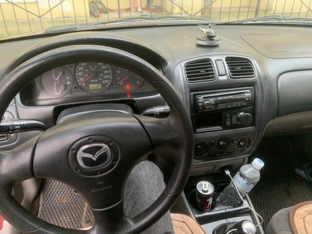 Червоний Мазда 323, об'ємом двигуна 2 л та пробігом 167 тис. км за 2400 $, фото 1 на Automoto.ua