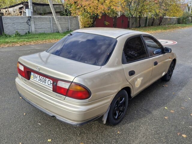 Серый Мазда 323, объемом двигателя 2 л и пробегом 234 тыс. км за 1350 $, фото 4 на Automoto.ua