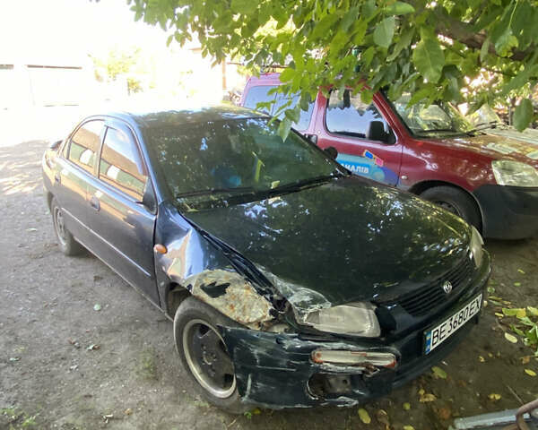 Синій Мазда 323, об'ємом двигуна 1.3 л та пробігом 395 тис. км за 1750 $, фото 4 на Automoto.ua