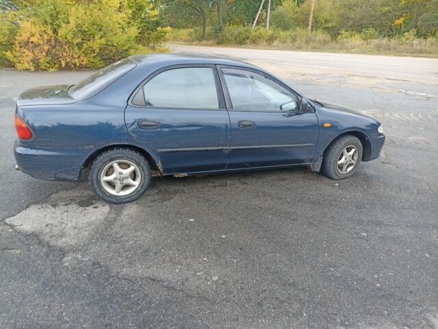 Синій Мазда 323, об'ємом двигуна 1.5 л та пробігом 250 тис. км за 1450 $, фото 2 на Automoto.ua