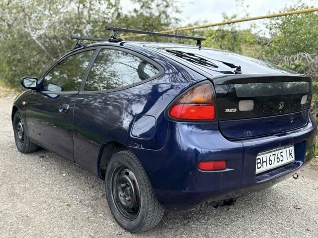 Синій Мазда 323, об'ємом двигуна 1.5 л та пробігом 200 тис. км за 1000 $, фото 3 на Automoto.ua