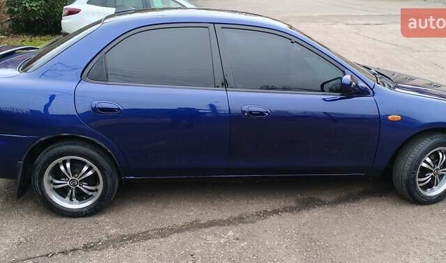 Синий Мазда 323, объемом двигателя 1.5 л и пробегом 342 тыс. км за 2600 $, фото 4 на Automoto.ua