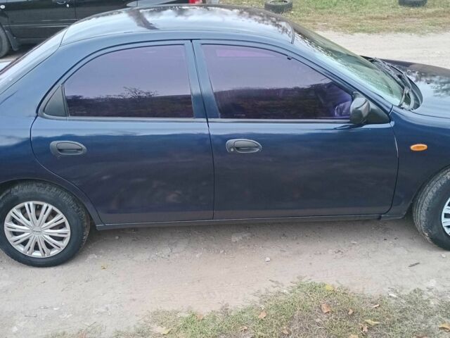 Синий Мазда 323, объемом двигателя 1.5 л и пробегом 74 тыс. км за 1950 $, фото 4 на Automoto.ua