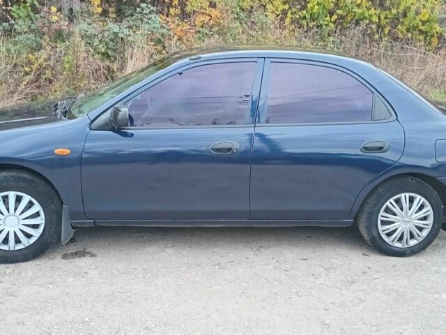 Синий Мазда 323, объемом двигателя 1.5 л и пробегом 74 тыс. км за 1950 $, фото 1 на Automoto.ua