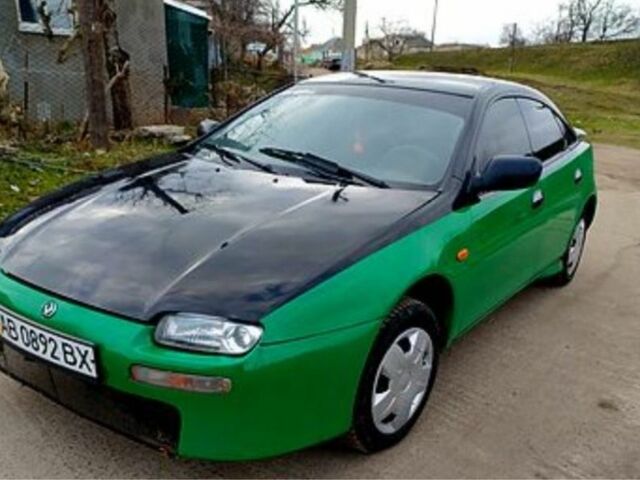 Зеленый Мазда 323, объемом двигателя 10 л и пробегом 100 тыс. км за 960 $, фото 1 на Automoto.ua