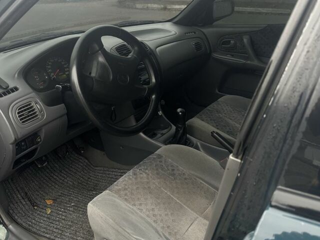 Зеленый Мазда 323, объемом двигателя 1.5 л и пробегом 400 тыс. км за 1500 $, фото 4 на Automoto.ua