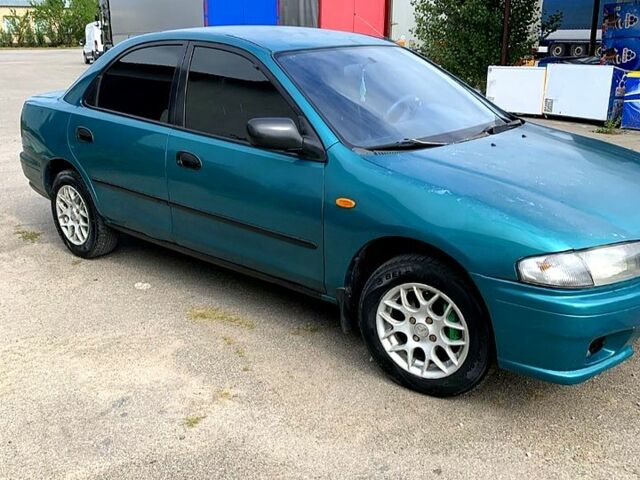 Зеленый Мазда 323, объемом двигателя 1.5 л и пробегом 254 тыс. км за 1800 $, фото 6 на Automoto.ua