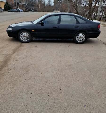 Черный Мазда 626, объемом двигателя 2.5 л и пробегом 380 тыс. км за 1500 $, фото 1 на Automoto.ua