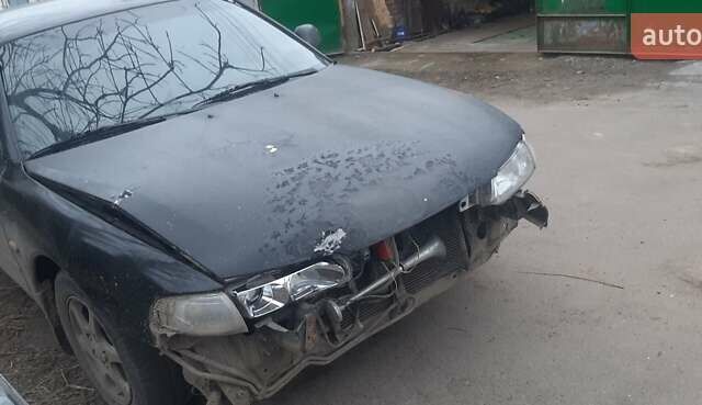 Черный Мазда 626, объемом двигателя 1.8 л и пробегом 520 тыс. км за 1900 $, фото 1 на Automoto.ua