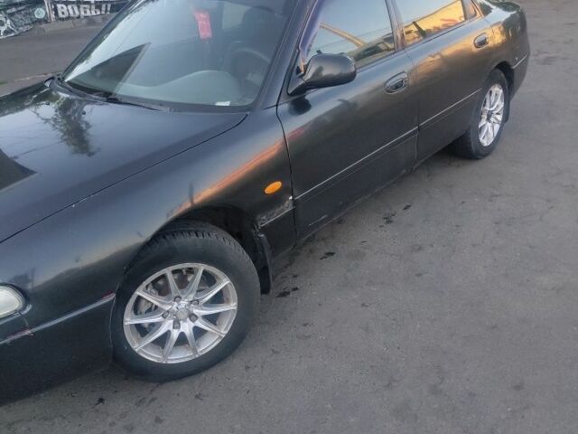 Черный Мазда 626, объемом двигателя 1.8 л и пробегом 101 тыс. км за 1500 $, фото 1 на Automoto.ua