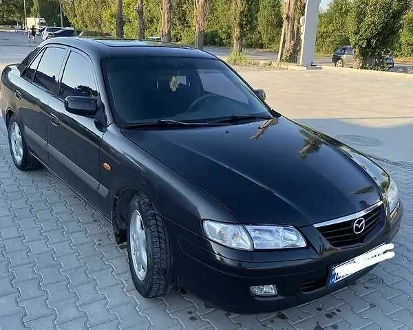 Черный Мазда 626, объемом двигателя 2 л и пробегом 210 тыс. км за 3000 $, фото 1 на Automoto.ua