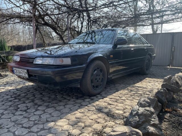 Черный Мазда 626, объемом двигателя 2 л и пробегом 320 тыс. км за 950 $, фото 1 на Automoto.ua