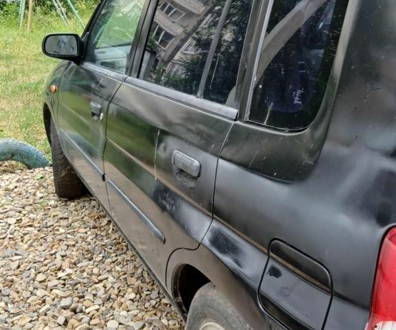 Черный Мазда Демио, объемом двигателя 1.5 л и пробегом 280 тыс. км за 2500 $, фото 1 на Automoto.ua