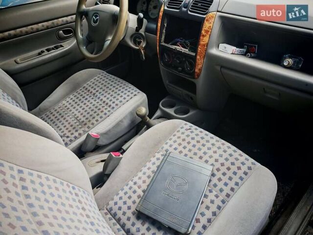 Черный Мазда Демио, объемом двигателя 1.5 л и пробегом 280 тыс. км за 2500 $, фото 8 на Automoto.ua