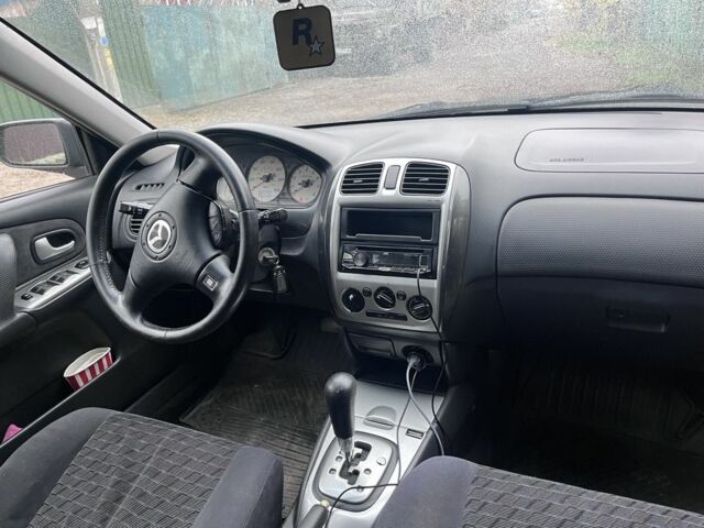 Синий Мазда Протеж, объемом двигателя 2 л и пробегом 298 тыс. км за 3700 $, фото 2 на Automoto.ua