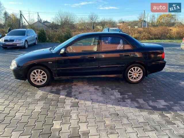 Черный Мицубиси Харизма, объемом двигателя 1.6 л и пробегом 30 тыс. км за 3000 $, фото 2 на Automoto.ua