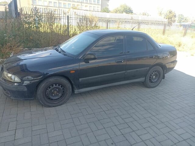 Черный Мицубиси Харизма, объемом двигателя 1.6 л и пробегом 402 тыс. км за 2200 $, фото 1 на Automoto.ua