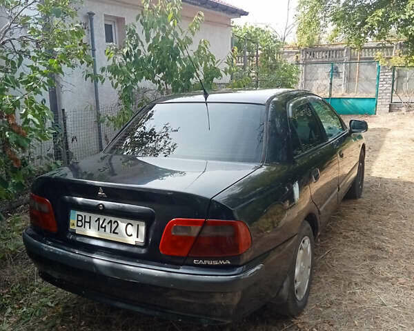 Черный Мицубиси Харизма, объемом двигателя 1.6 л и пробегом 167 тыс. км за 3100 $, фото 1 на Automoto.ua