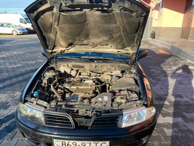 Черный Мицубиси Харизма, объемом двигателя 1.6 л и пробегом 30 тыс. км за 3000 $, фото 4 на Automoto.ua