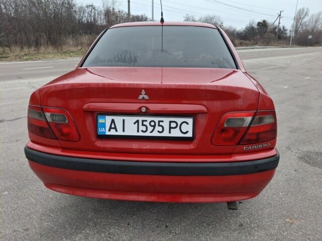 Красный Мицубиси Харизма, объемом двигателя 1.6 л и пробегом 310 тыс. км за 3199 $, фото 1 на Automoto.ua
