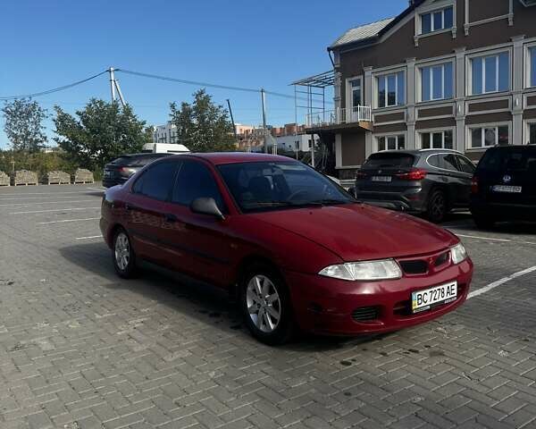 Красный Мицубиси Харизма, объемом двигателя 1.8 л и пробегом 350 тыс. км за 1900 $, фото 1 на Automoto.ua