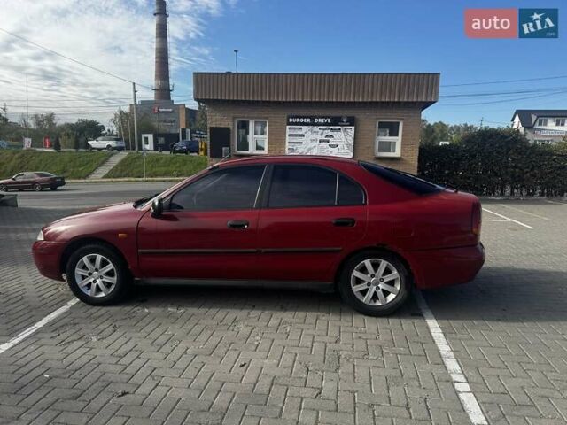 Красный Мицубиси Харизма, объемом двигателя 1.8 л и пробегом 350 тыс. км за 1900 $, фото 2 на Automoto.ua