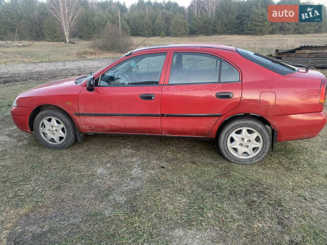 Красный Мицубиси Харизма, объемом двигателя 1.9 л и пробегом 350 тыс. км за 3000 $, фото 4 на Automoto.ua
