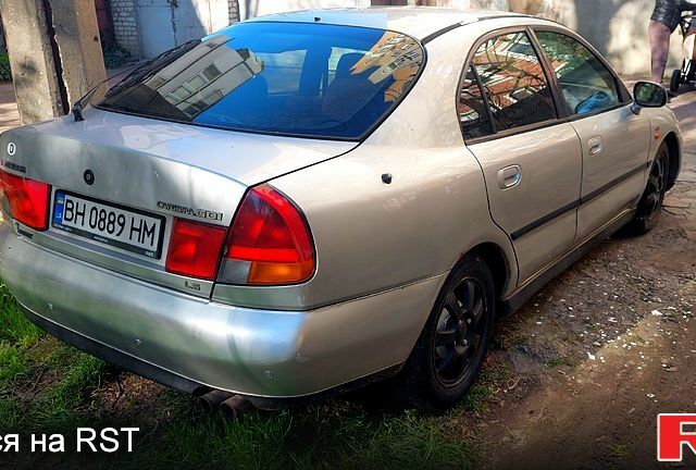 Серый Мицубиси Харизма, объемом двигателя 1.8 л и пробегом 320 тыс. км за 1600 $, фото 2 на Automoto.ua