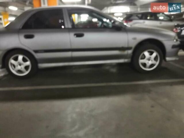 Серый Мицубиси Харизма, объемом двигателя 1.6 л и пробегом 270 тыс. км за 2300 $, фото 1 на Automoto.ua