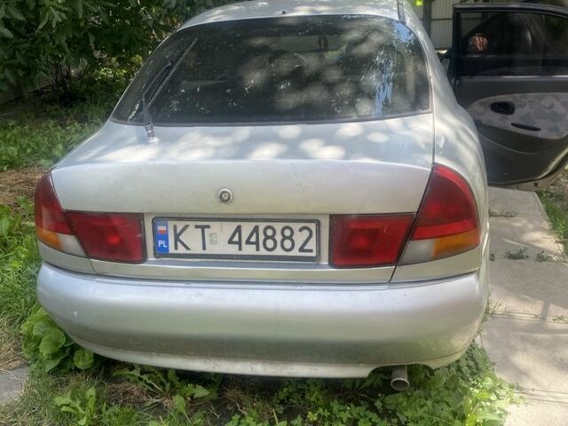 Серый Мицубиси Харизма, объемом двигателя 1.8 л и пробегом 202 тыс. км за 1100 $, фото 4 на Automoto.ua