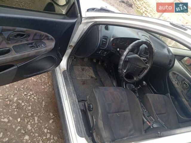 Серый Мицубиси Харизма, объемом двигателя 1.9 л и пробегом 65 тыс. км за 1650 $, фото 1 на Automoto.ua