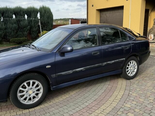 Синий Мицубиси Харизма, объемом двигателя 1.8 л и пробегом 275 тыс. км за 3000 $, фото 2 на Automoto.ua