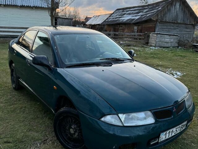 Зеленый Мицубиси Харизма, объемом двигателя 1 л и пробегом 475 тыс. км за 1299 $, фото 1 на Automoto.ua