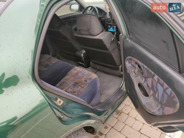 Зеленый Мицубиси Харизма, объемом двигателя 1.83 л и пробегом 255 тыс. км за 3500 $, фото 17 на Automoto.ua