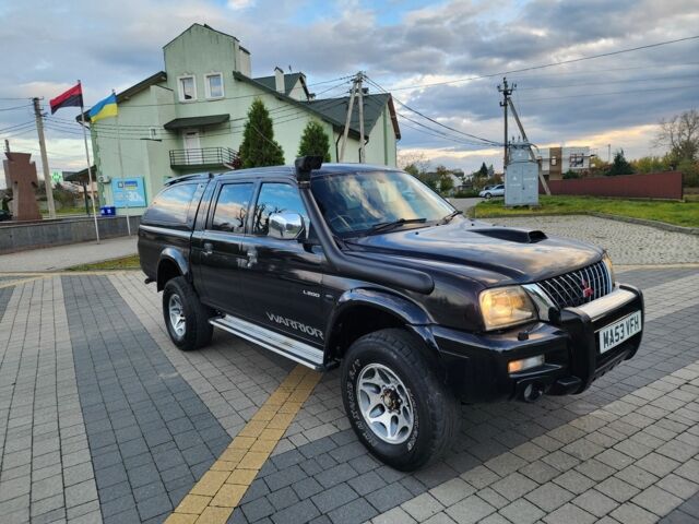 Черный Мицубиси Л 200, объемом двигателя 2.5 л и пробегом 156 тыс. км за 7521 $, фото 1 на Automoto.ua