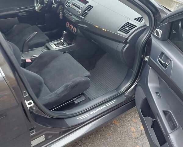 Черный Мицубиси Лансер Эволюшн, объемом двигателя 2 л и пробегом 116 тыс. км за 16900 $, фото 8 на Automoto.ua