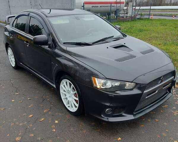 Черный Мицубиси Лансер Эволюшн, объемом двигателя 2 л и пробегом 116 тыс. км за 16900 $, фото 1 на Automoto.ua