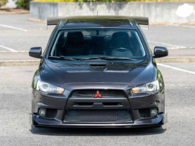 Черный Мицубиси Лансер Эволюшн, объемом двигателя 2 л и пробегом 90 тыс. км за 6400 $, фото 1 на Automoto.ua