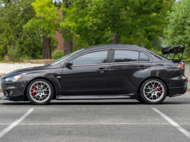 Черный Мицубиси Лансер Эволюшн, объемом двигателя 2 л и пробегом 90 тыс. км за 6400 $, фото 4 на Automoto.ua