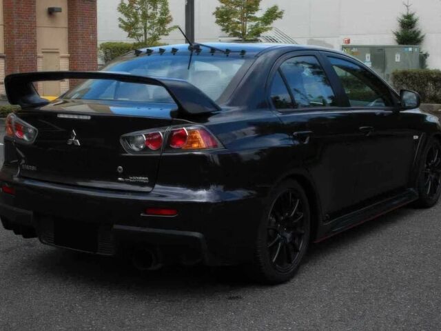 Черный Мицубиси Лансер Эволюшн, объемом двигателя 2 л и пробегом 88 тыс. км за 6400 $, фото 5 на Automoto.ua